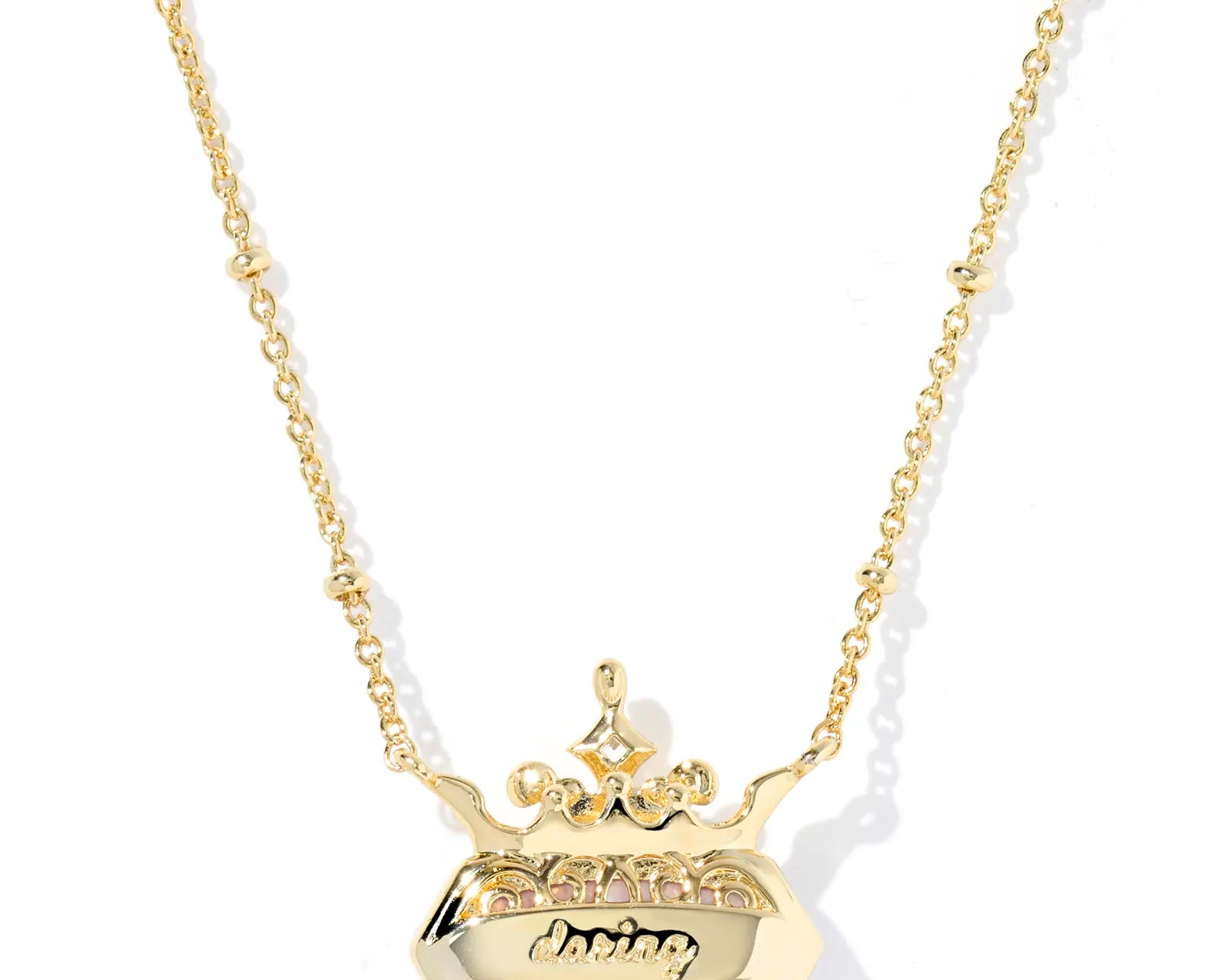 Kendra Scott Disney Princess Elisa Necklace, Ninth View, the engraved back of the gold pendant reading daring