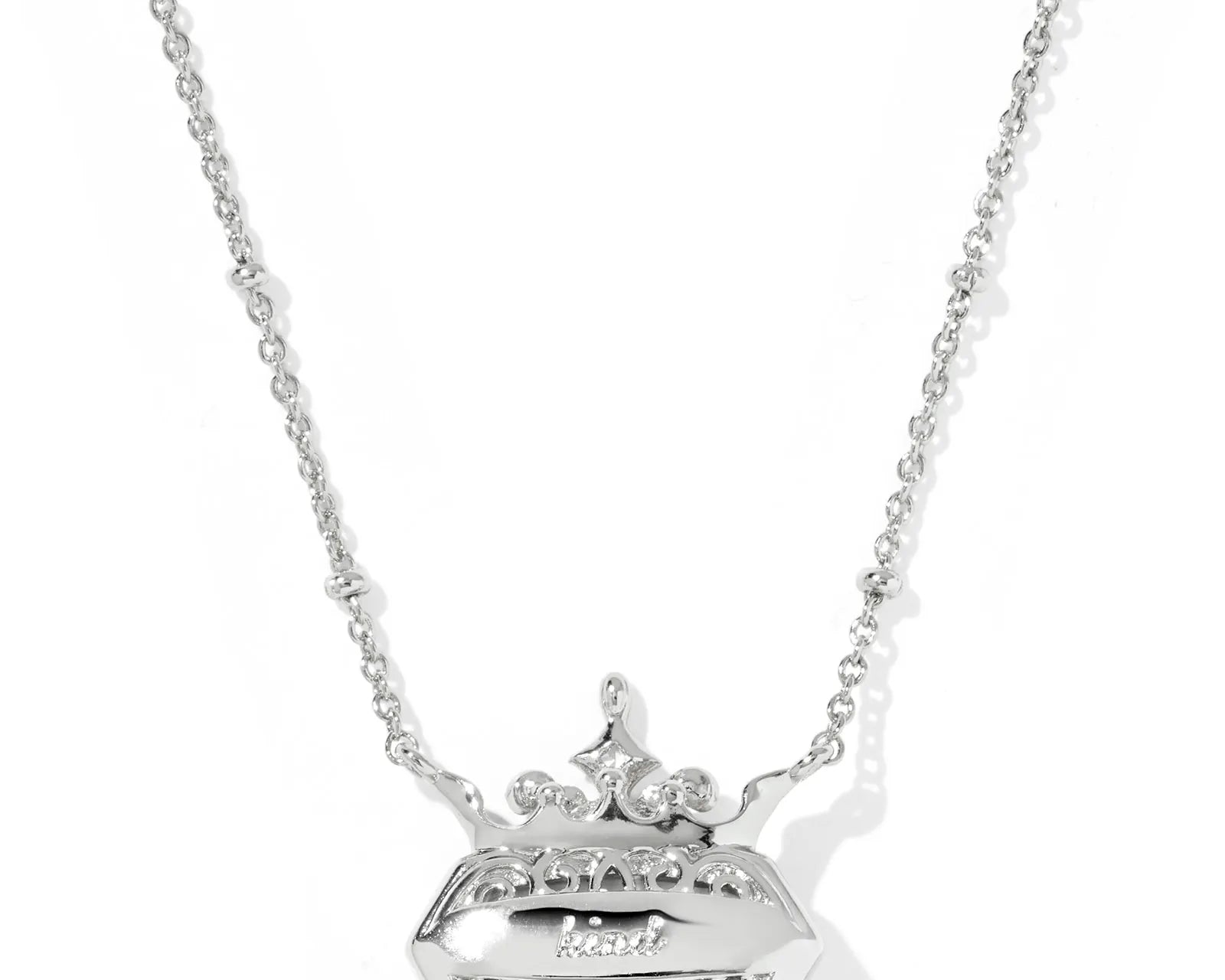Kendra Scott Disney Princess Elisa Necklace, Tenth View, the engraved back of the silver pendant reading kind