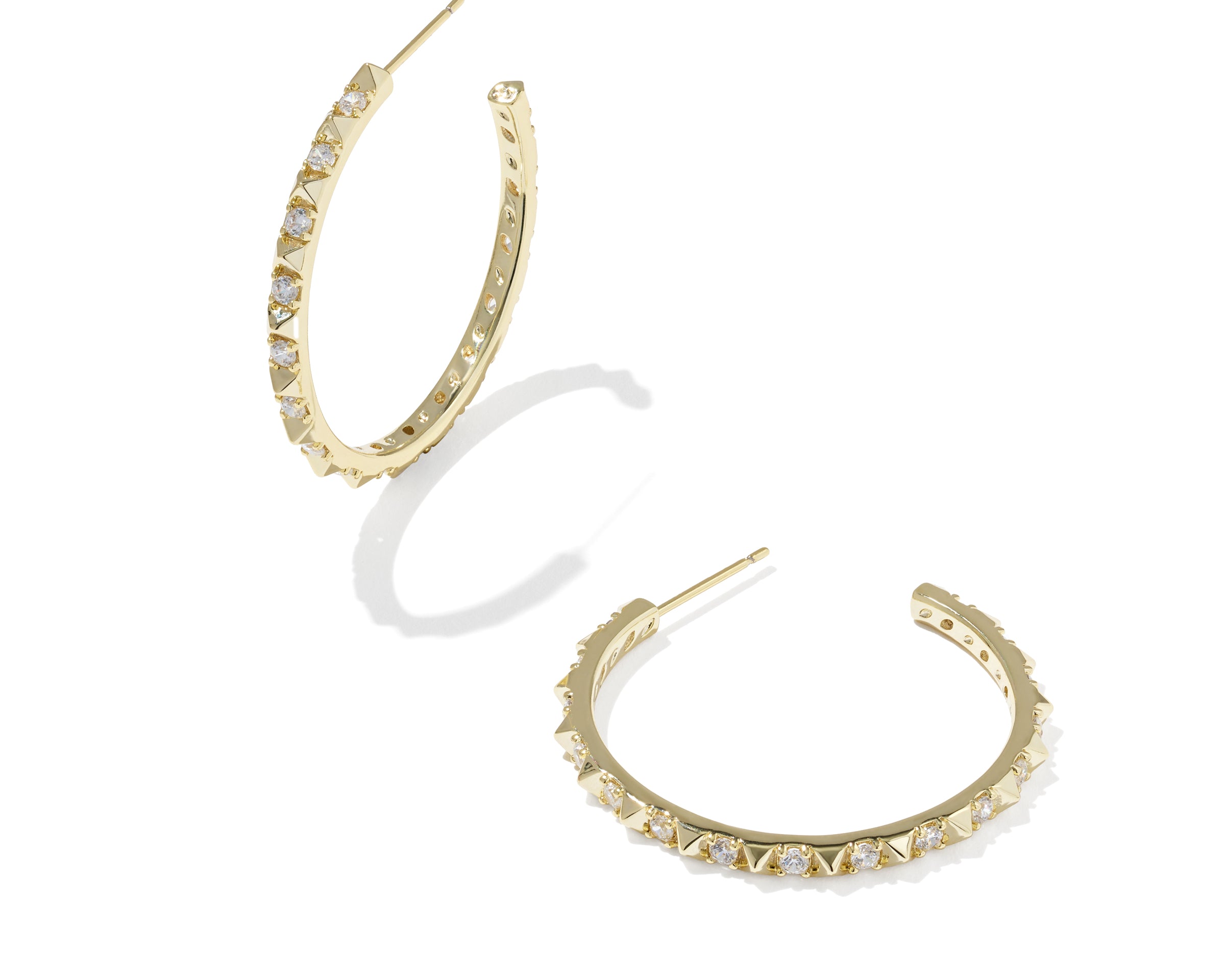 Kendra Scott Fate Hoop Earrings in gold, a pair of open hoops lined with small spikes and cubic zirconia