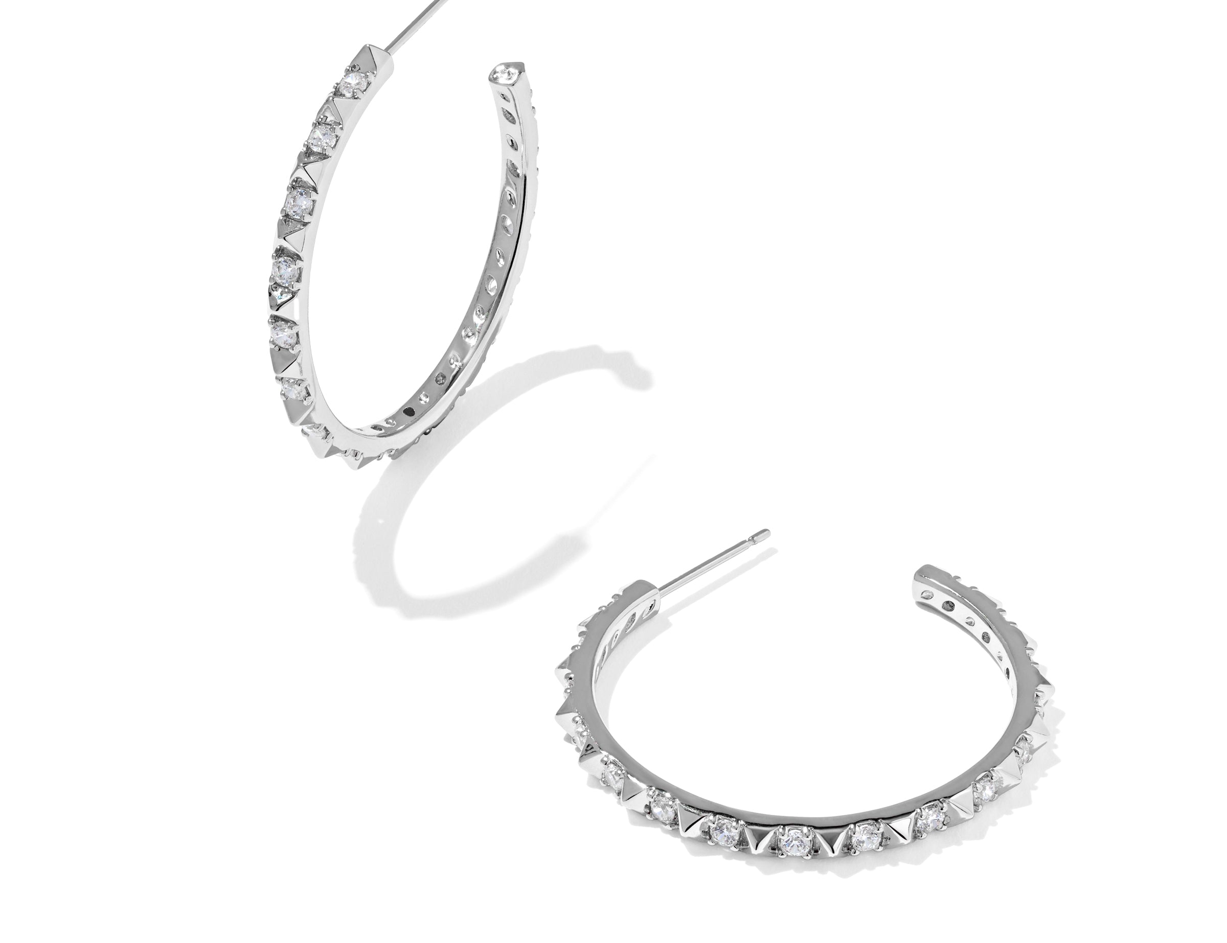 Kendra Scott Fate Hoop Earrings in rhodium silver, a pair of open hoops lined with small spikes and cubic zirconia