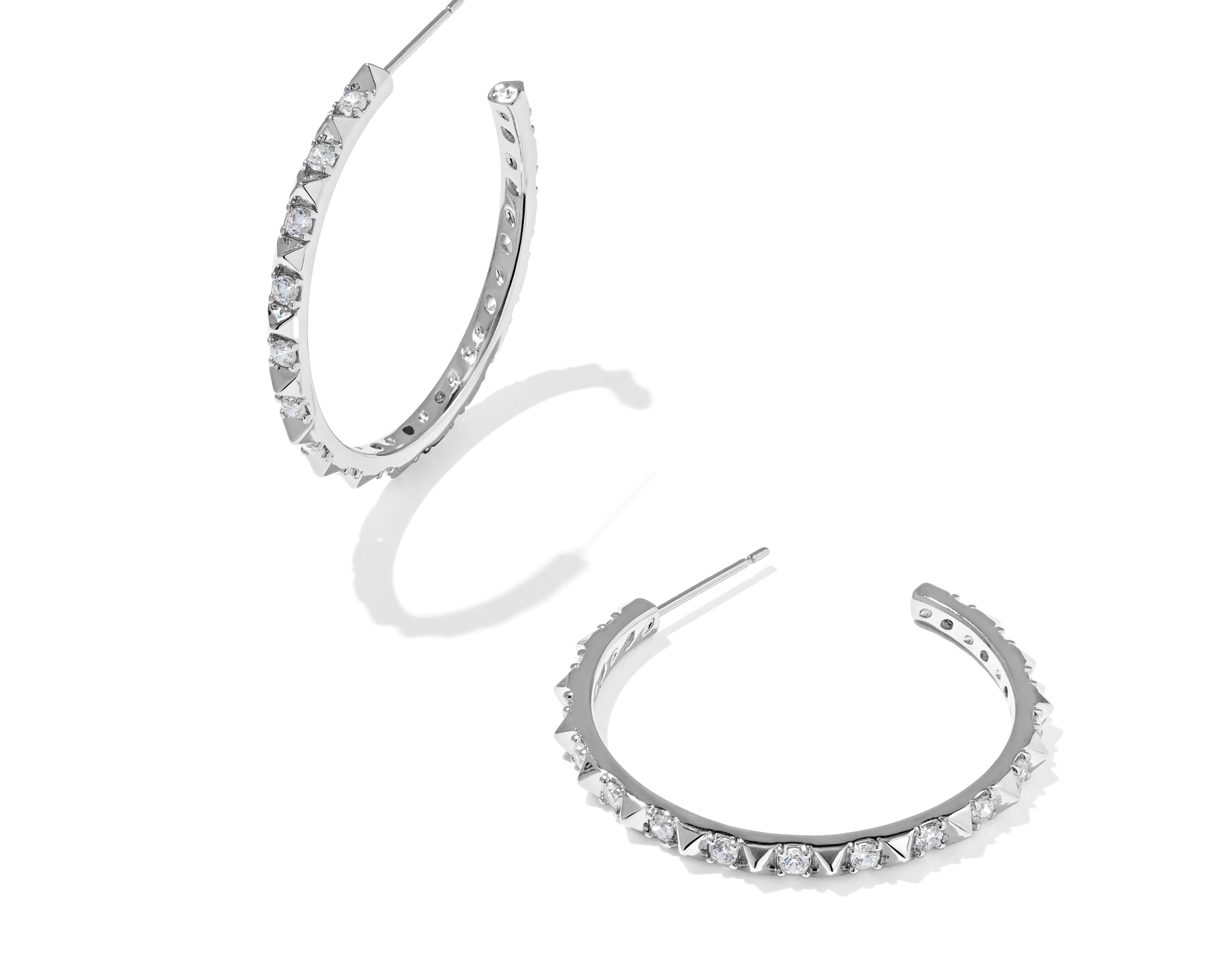 Kendra Scott Fate Hoop Earrings in rhodium silver, a pair of open hoops lined with small spikes and cubic zirconia