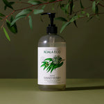 Koala Eco Natural Hand Wash bottle under eucalyptus branches on a green background