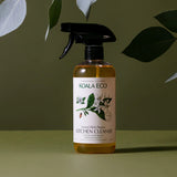 Koala Eco Natural Multi-Purpose Kitchen Cleaner bottle under green leaves on a green background