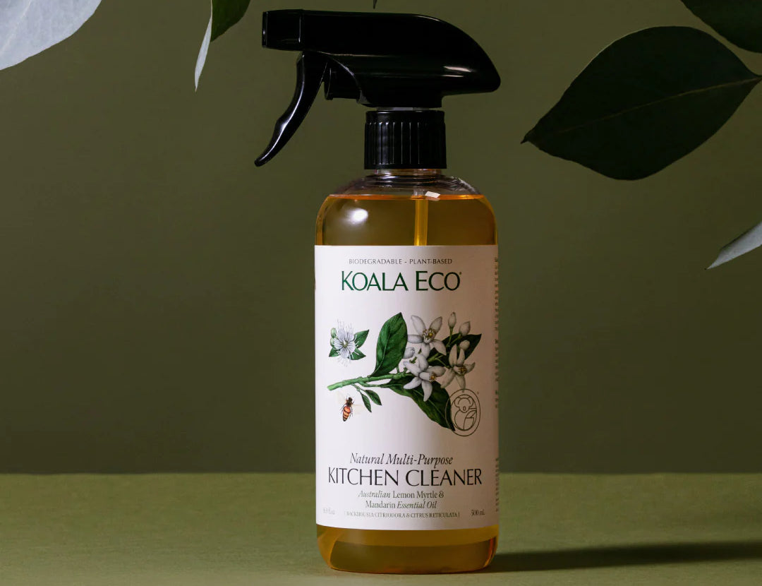 Koala Eco Natural Multi-Purpose Kitchen Cleaner bottle under green leaves on a green background