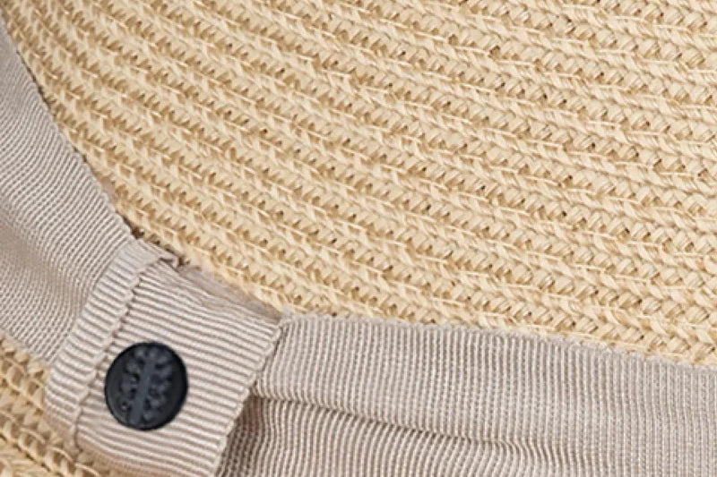 Close-up of the gray ribbon band and button detail on the Kooringal Cypress Safari straw fedora