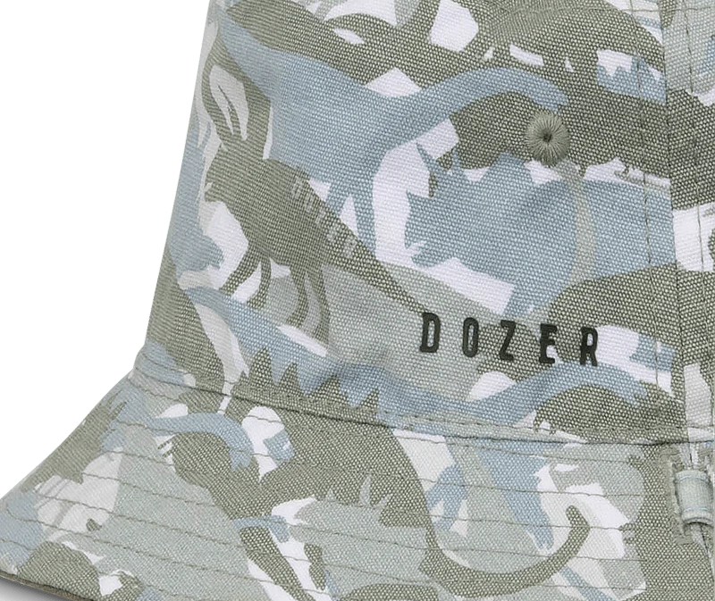 Close-up of the green dinosaur camo print and Dozer logo on the Kooringal Boys Bucket Hat in Clifton Camo