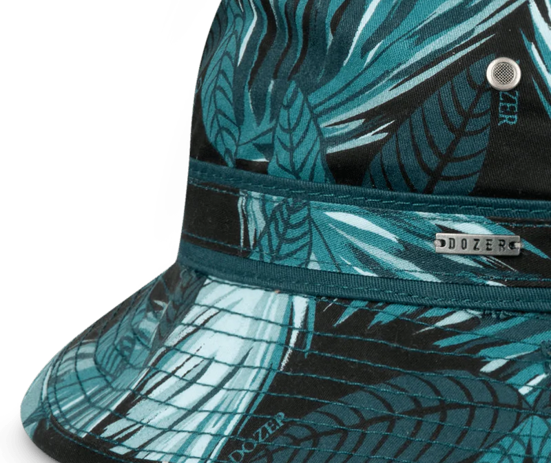 Close-up of the teal palm leaf print, eyelet and Dozer tag on the Kooringal Boys Bucket Hat in Hideaway