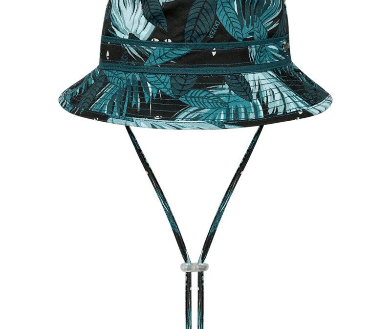 Kooringal Dozer Boys Bucket Hat in Hideaway, a black bucket hat with a teal tropical leaf print and chin cord