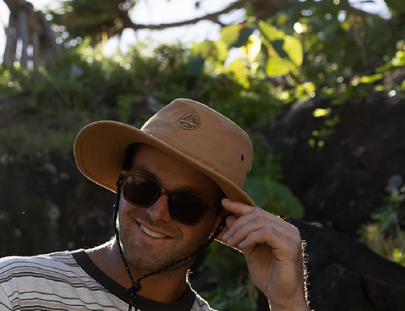 Smiling man in sunglasses wearing the Kooringal Men's Mid Brim Surfside hat in Camel