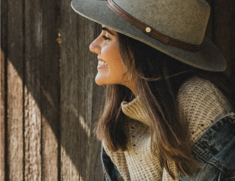 Smiling woman in a denim jacket wearing the Kooringal Women's Safari Kallie hat in Grey Marle