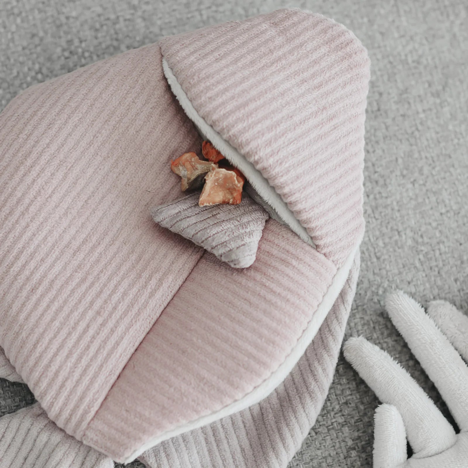 Lambwolf Collective Angel Fish Dog Toy in pink corduroy, close-up of a treat tucked into the snuffle pocket