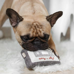French bulldog resting its chin on the Lambwolf Collective Cassette Dog Toy on a fluffy rug