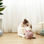 Border collie chewing the Lambwolf Collective Monti Enrichment Dog Toy in Pink on a wood floor