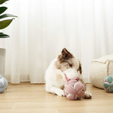 Border collie chewing the Lambwolf Collective Monti Enrichment Dog Toy in Pink on a wood floor