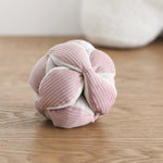Lambwolf Collective Monti Enrichment Dog Toy in Pink on a wood floor