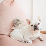 French bulldog lying on a pink cushion beside the Lambwolf Collective Snail Snuffle Dog Toy