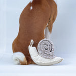 Lambwolf Collective Snail Snuffle Dog Toy resting on the back of a Boston terrier
