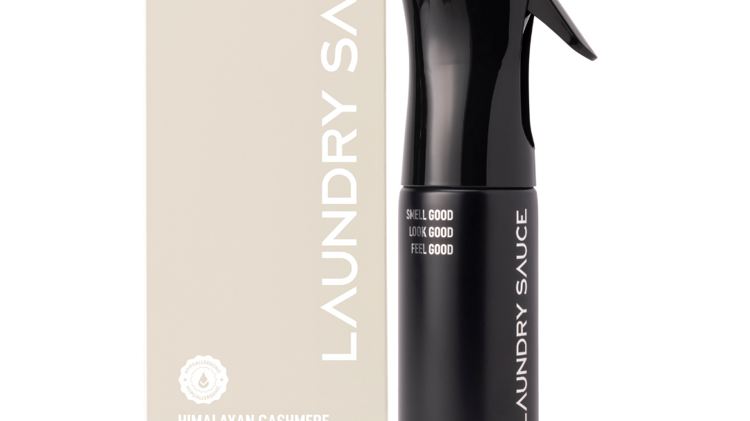 Laundry Sauce Fabric Refresher Spray in Himalayan Cashmere, a black spray bottle beside its cream box