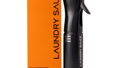 Laundry Sauce Fabric Refresher Spray in Italian Bergamot, a black spray bottle beside its orange box