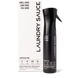 Laundry Sauce Fabric Refresher Spray in Siberian Pine, a black spray bottle beside its white box