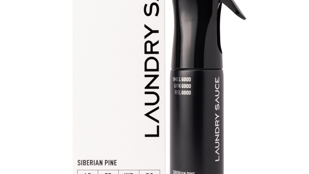 Laundry Sauce Fabric Refresher Spray in Siberian Pine, a black spray bottle beside its white box