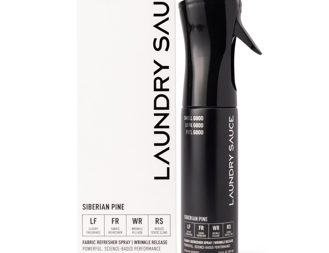 Laundry Sauce Fabric Refresher Spray in Siberian Pine, a black spray bottle beside its white box