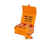 Laundry Sauce Laundry Detergent Pods in Italian Bergamot, an open orange box of amber pods