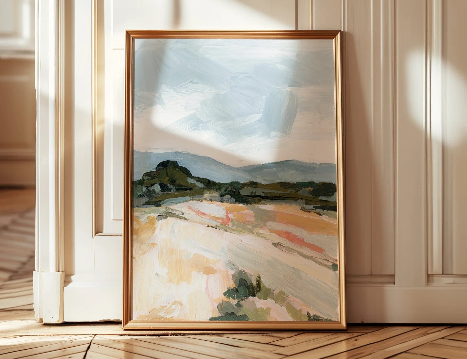 Laurie Anne Art Blue Desert Fine Art Print in a thin gold frame leaning against a wall on a wood floor