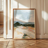 Laurie Anne Art Blue Desert Fine Art Print in a thin gold frame leaning against a wall on a wood floor