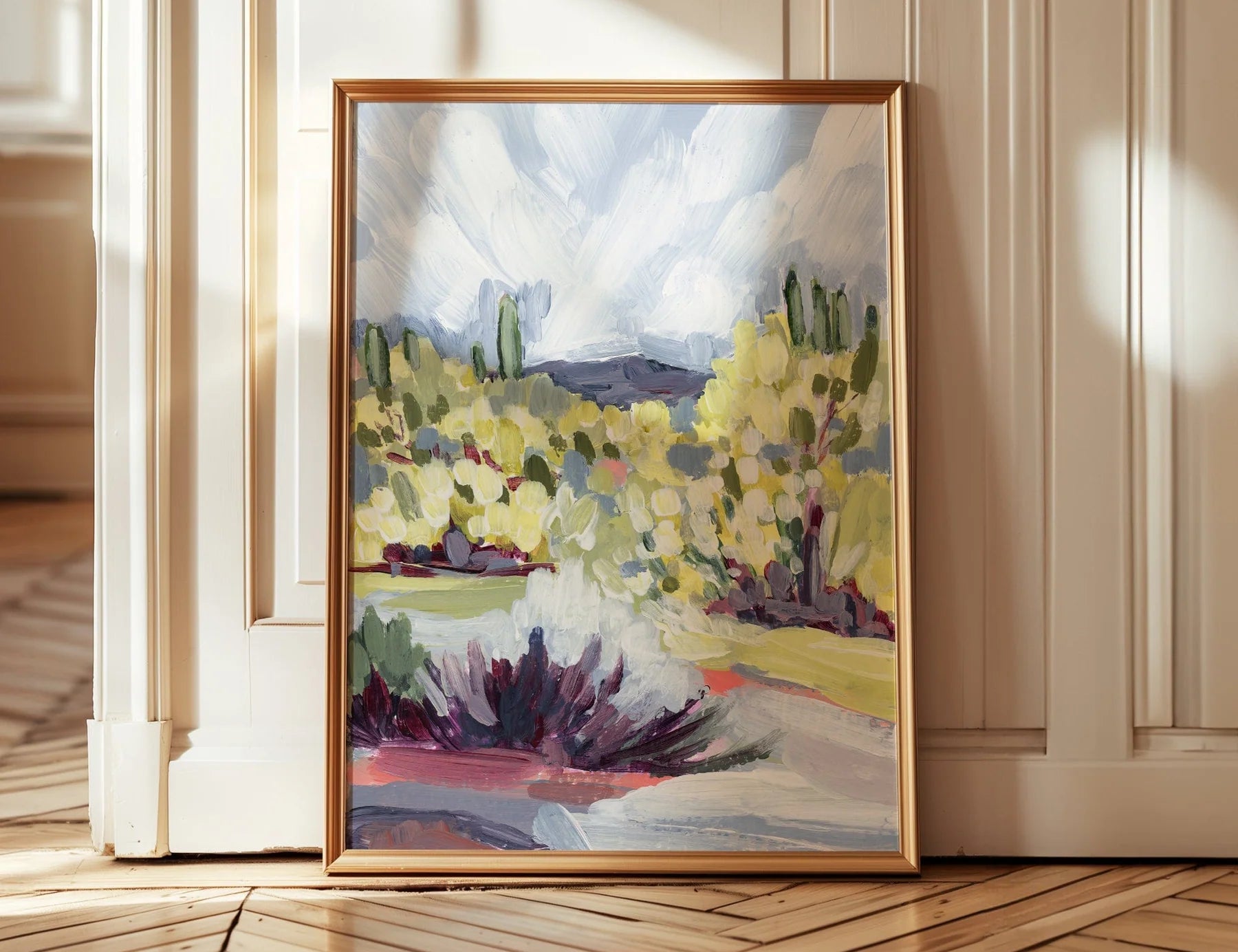 Laurie Anne Art Brush Desert Fine Art Print in a thin gold frame leaning against a wall on a wood floor