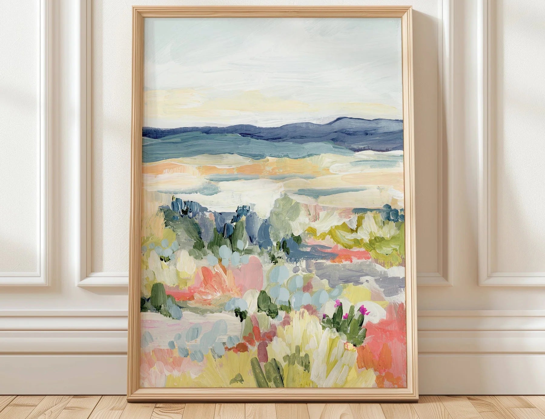 Laurie Anne Art Desert Dawn Fine Art Print in a thin wood frame leaning against a white paneled wall