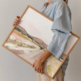 Person in a blue shirt holding the framed Laurie Anne Art Desert Road Fine Art Print