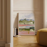 Laurie Anne Art Periwinkle Desert Fine Art Print in a wood frame leaning against a wall in a sunlit room