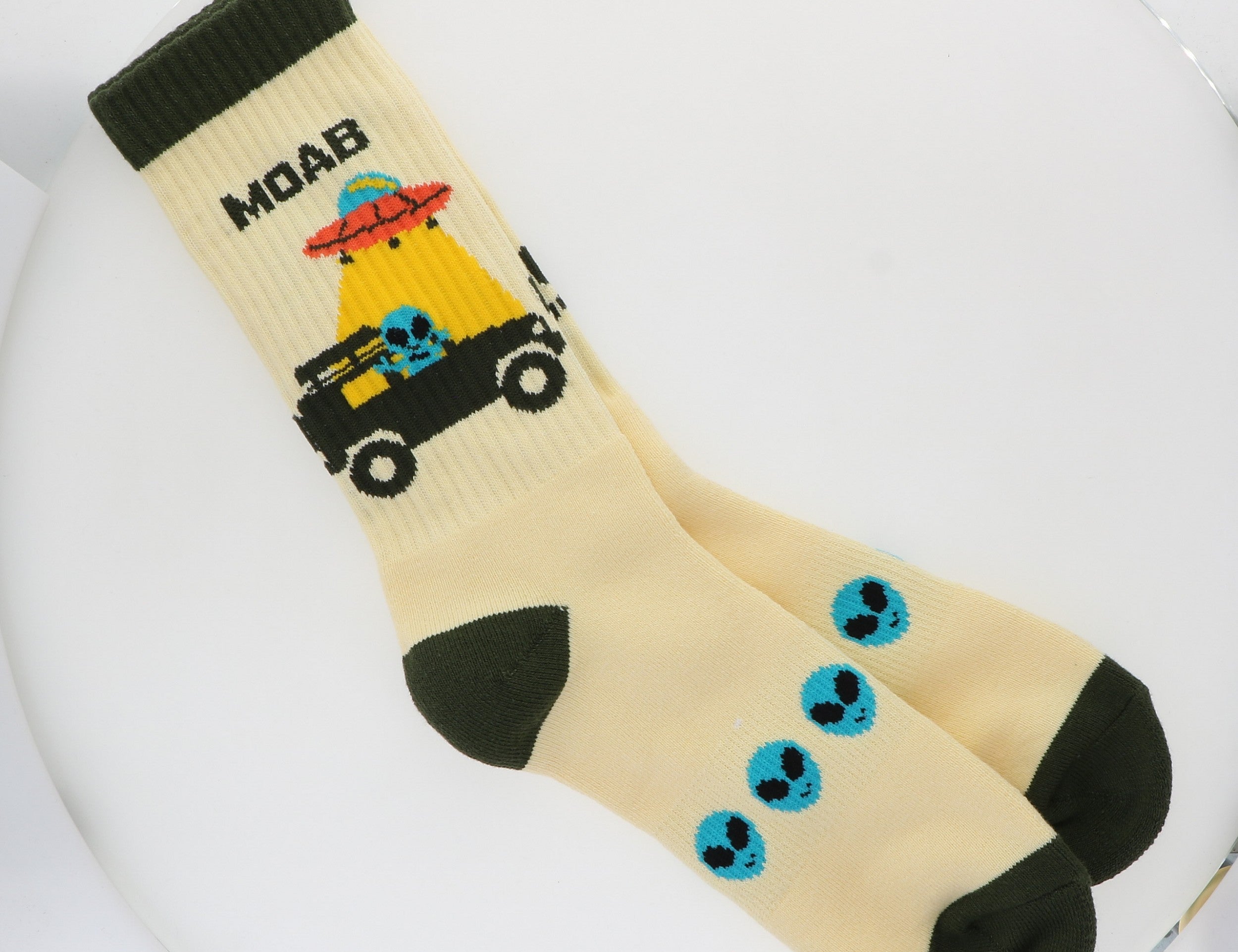 Locale Alien Jeeping in Moab Cream Socks, cream crew socks with a UFO, jeep and green alien design and dark green toes