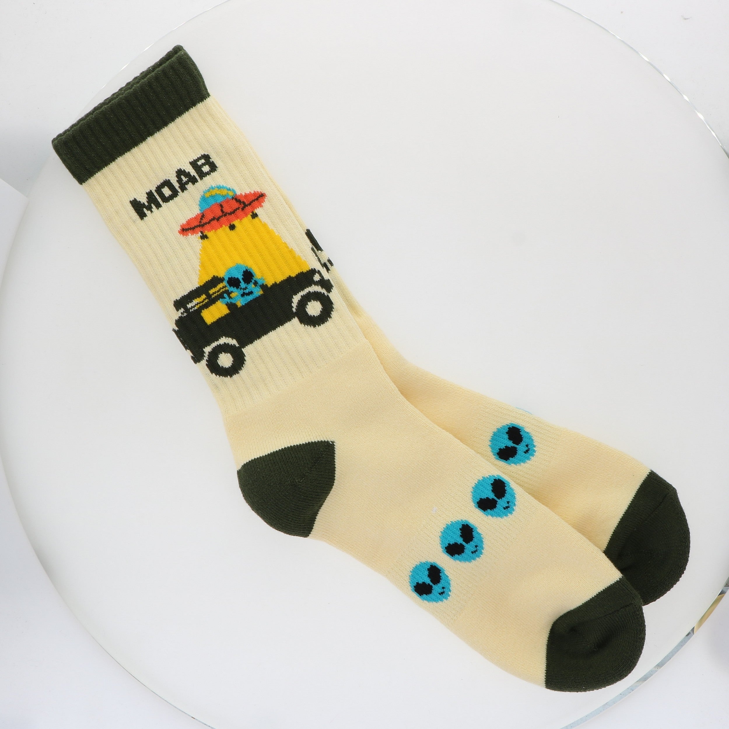 Locale Alien Jeeping in Moab Cream Socks, cream crew socks with a UFO, jeep and green alien design and dark green toes
