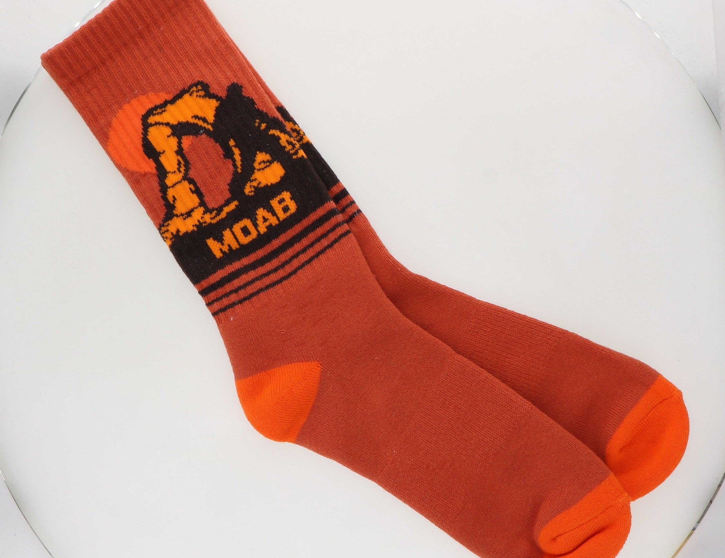 Locale Delicate Arch Yeti Socks, rust orange crew socks with a yeti at Delicate Arch and the word Moab