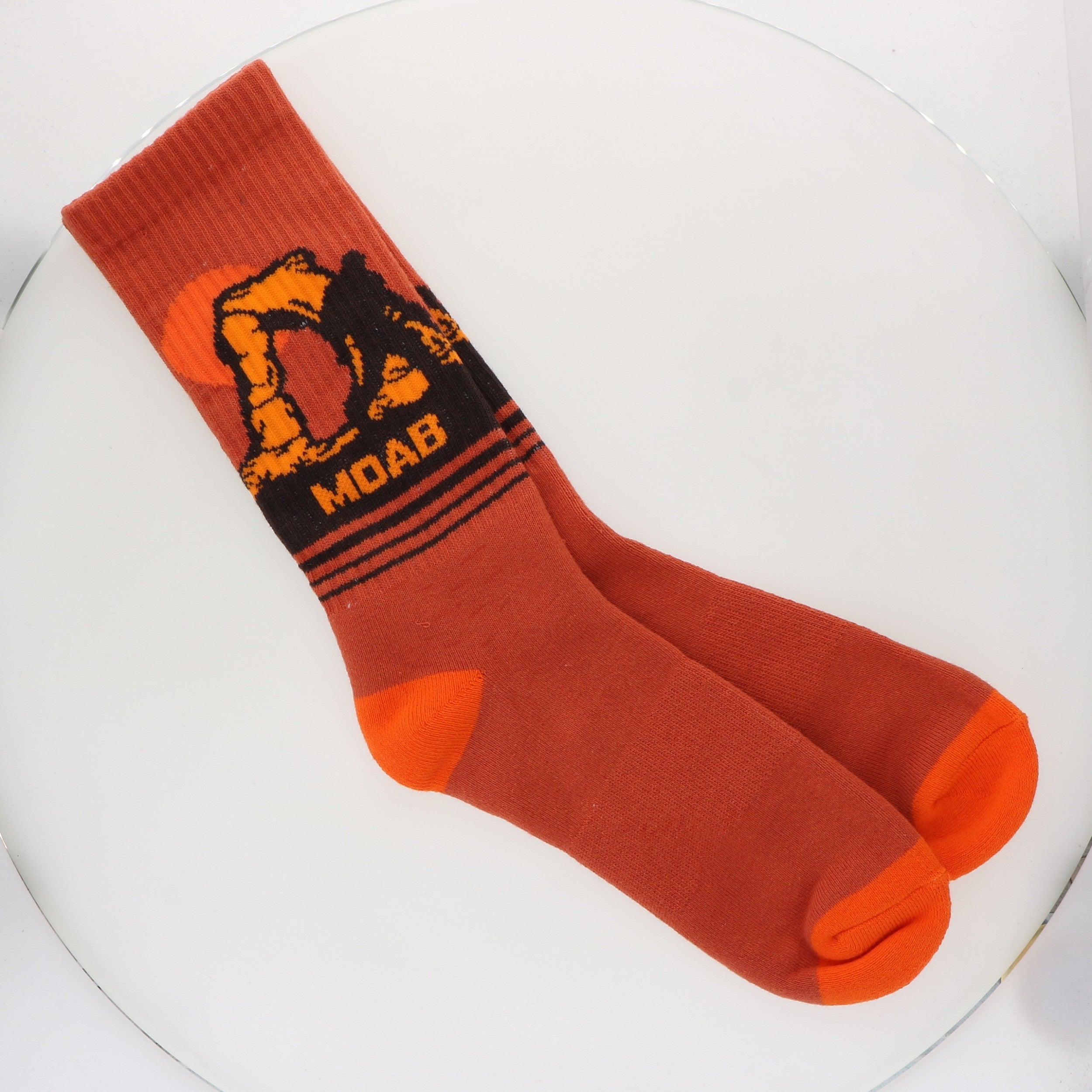 Locale Delicate Arch Yeti Socks, rust orange crew socks with a yeti at Delicate Arch and the word Moab