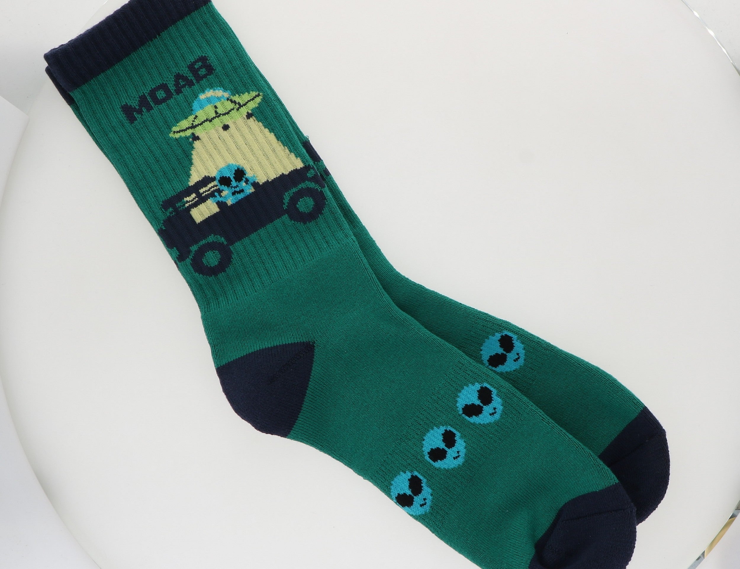Locale Teal Alien Jeeping in Moab Socks, teal crew socks with an alien driving a Jeep and navy trim