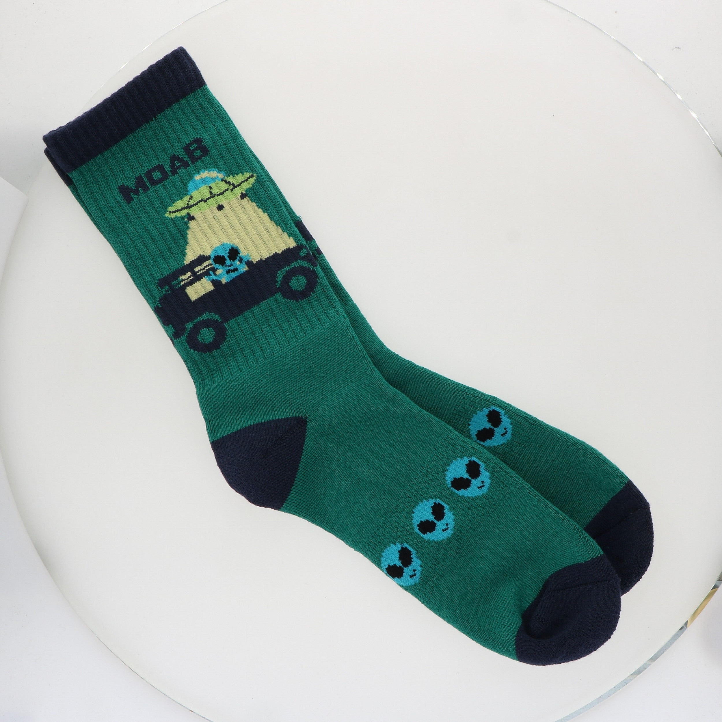 Locale Teal Alien Jeeping in Moab Socks, teal crew socks with an alien driving a Jeep and navy trim
