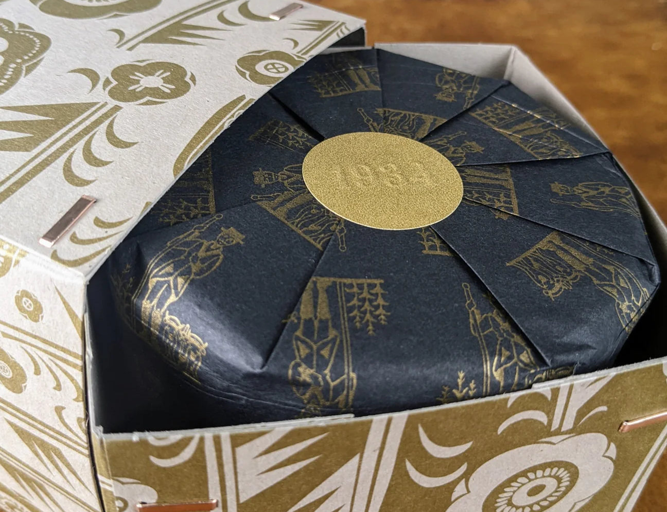 Los Poblanos Herbal Bug Repellent candle box with a gold and black botanical print