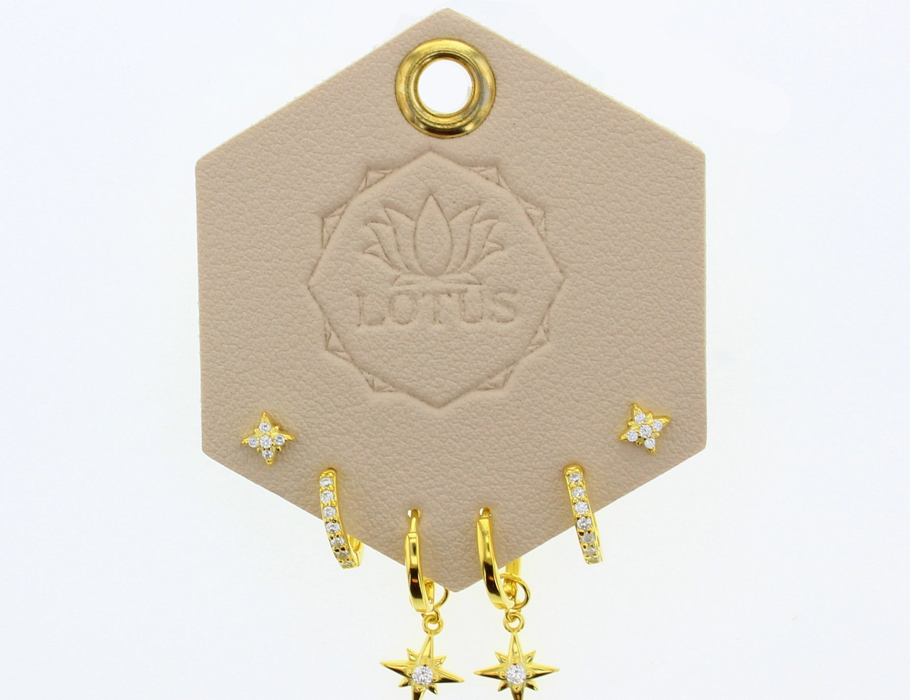 Lotus Studio Gold Trio Earrings in Amelia, star studs, pave huggies and star drop hoops on a Lotus card
