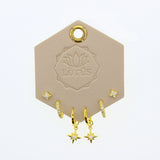 Lotus Studio Gold Trio Earrings in Amelia, star studs, pave huggies and star drop hoops on a Lotus card