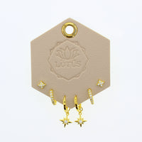 Lotus Studio Gold Trio Earrings in Amelia, star studs, pave huggies and star drop hoops on a Lotus card