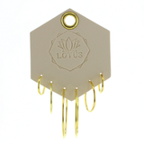 Lotus Studio Gold Trio Earrings in Hoop, three pairs of thin gold hoops in graduated sizes on a Lotus card