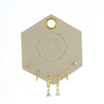 Lotus Studio Gold Trio Earrings in Lucy, crystal studs, huggies and teardrop crystal hoops on a Lotus card