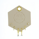 Lotus Studio Gold Trio Earrings in Lucy, crystal studs, huggies and teardrop crystal hoops on a Lotus card