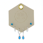 Lotus Studio Silver Trio Earrings in Andy, turquoise studs, silver huggies and turquoise drop hoops on a Lotus card