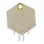 Lotus Studio Silver Trio Earrings in Audrey, dot studs, pave huggies and pearl drop hoops on a Lotus card