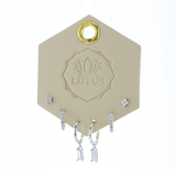 Lotus Studio Silver Trio Earrings in Camila, flower studs, pave huggies and baguette drop hoops on a Lotus card