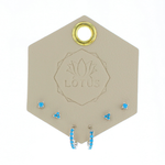 Lotus Studio Silver Trio Earrings in Eva, turquoise flower studs, star studs and turquoise huggies on a Lotus card